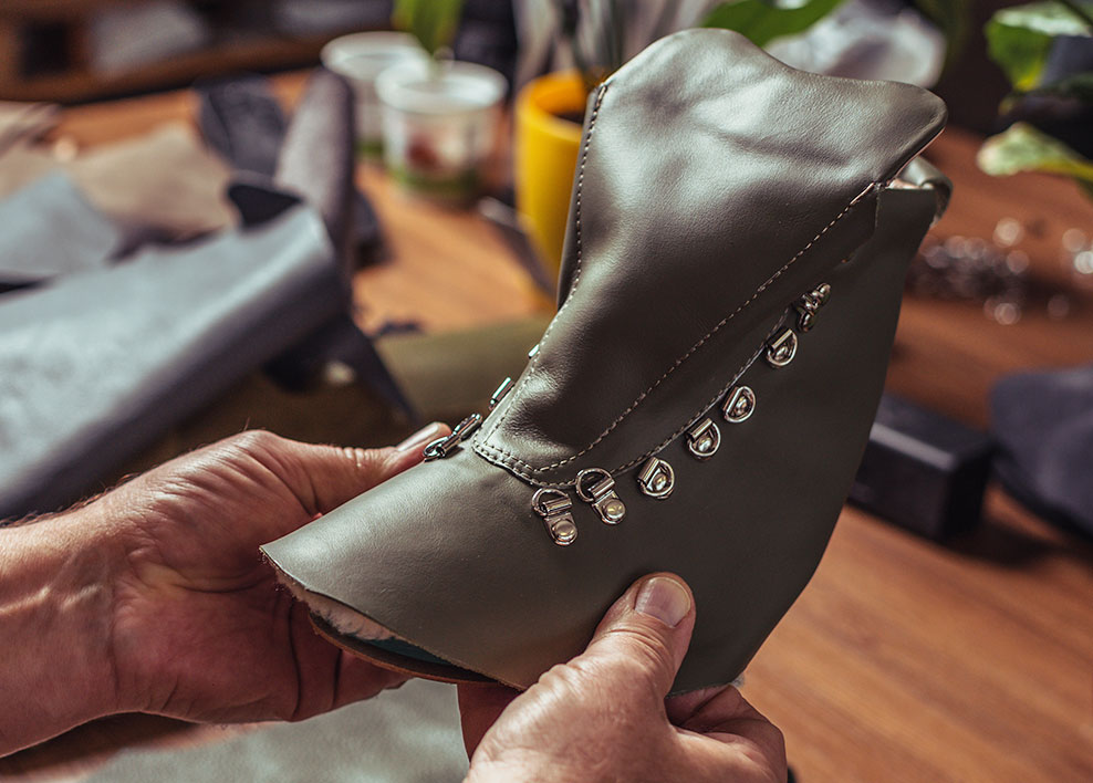 Leather worker inspecting a work boot upper