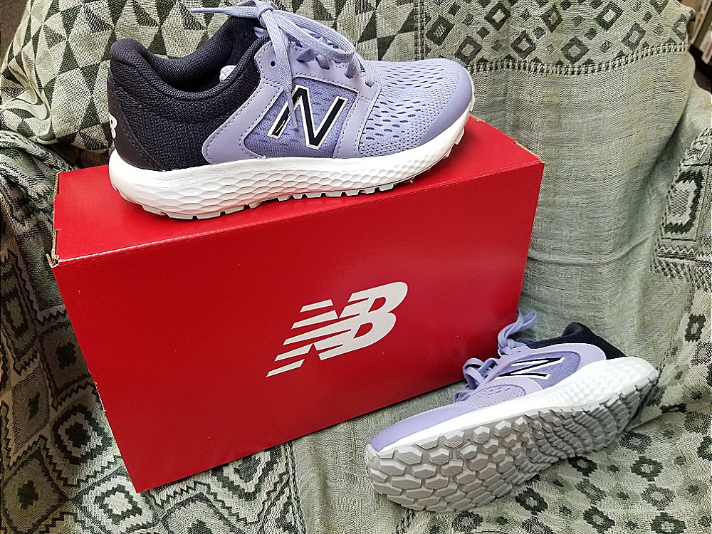 A pair of New Balance running shoes on a shoe store display