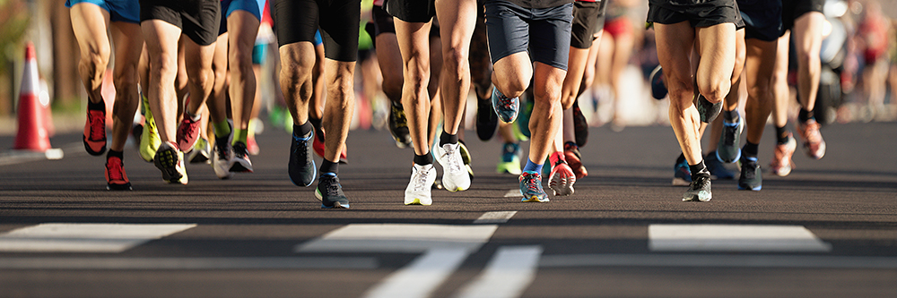 Row of runners legs, who are competing in a marathon