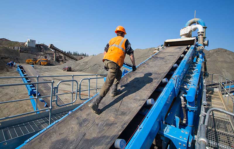 Miner Climbing up Machinery