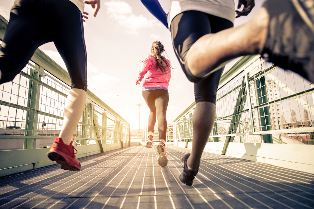 Runners crossing a bridge